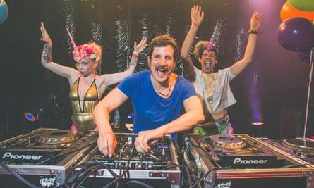 Publicity image for the Mighty Hoop-la weekender with a DJ on the decks and two friends partying.