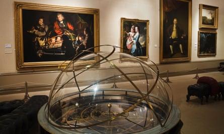 A solar system model – an orrery – in front of Joseph Wright’s painting The Orrery, Joseph Wright Gallery,.