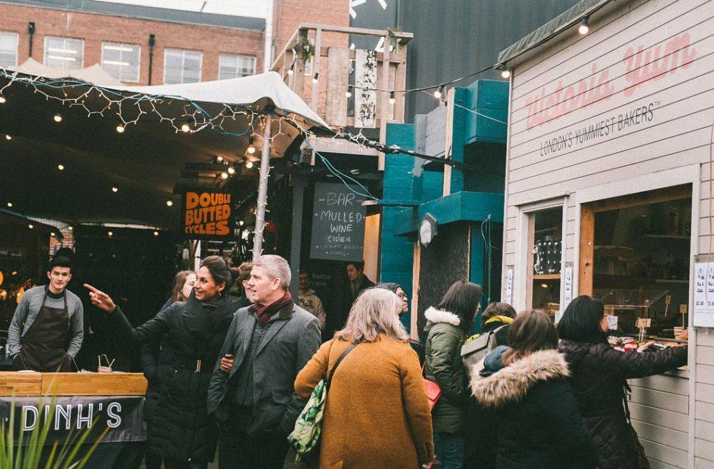 People buying some food at the Netil Market in London Fields, London 