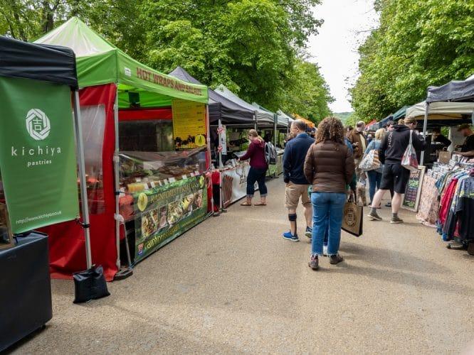 People wandering down past various different stalls at Alexandra Palace Farmer's Market