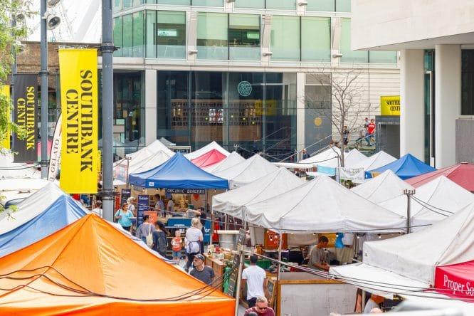 People perusing the food stalls of Southbank Food Market, one of the best weekend markets in London