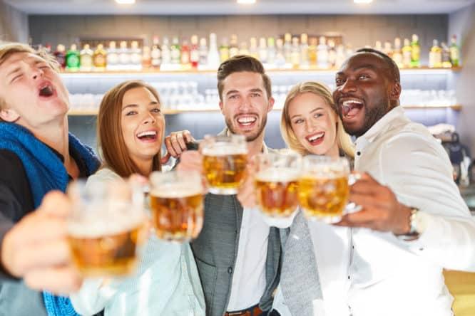 A group of friends drinking some pints on a pub crawl in London