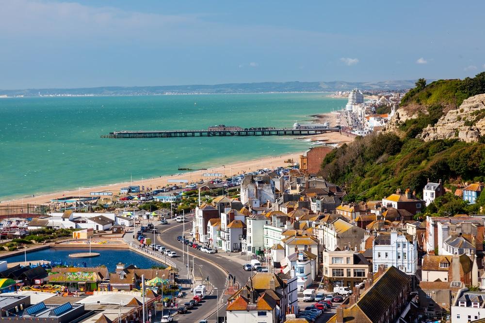 The beach and pier of Hastings in Sussex, England, one of the best seaside towns near London