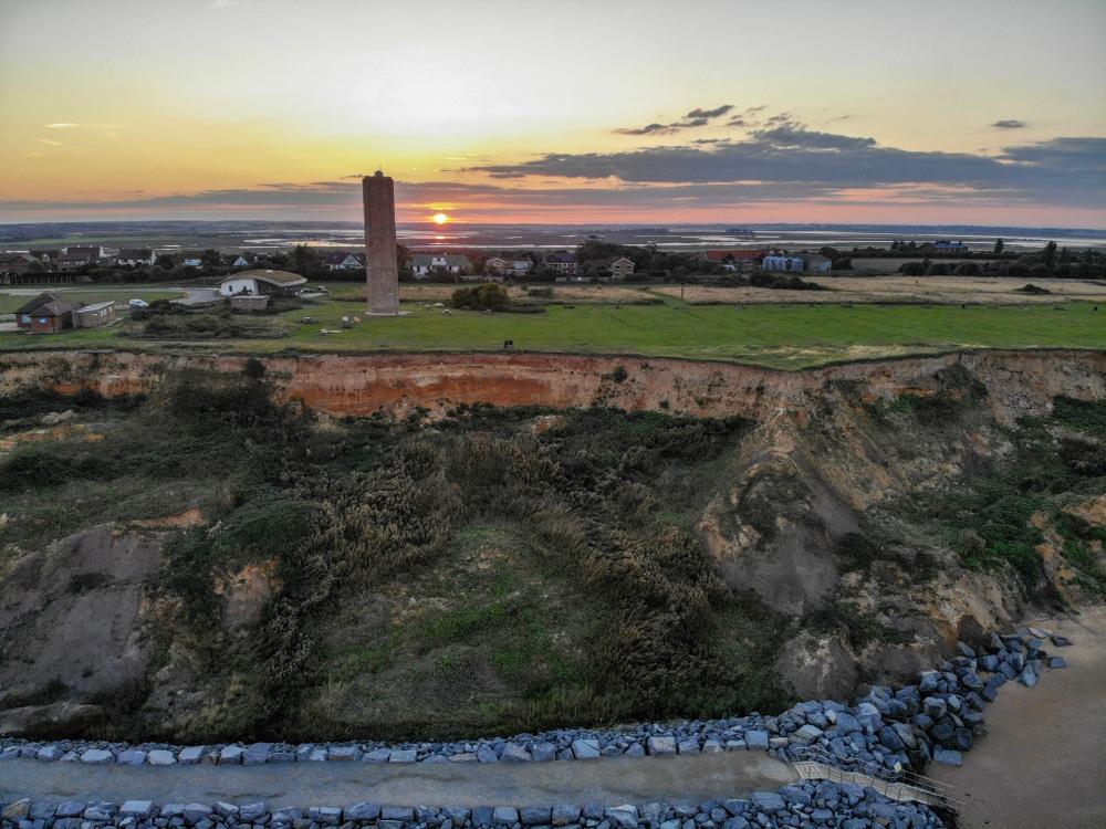 The sun setting over the cliffs and the town of Walton-on-the-Naze